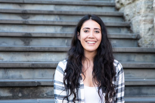 Female student sitting outside smiling