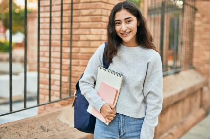 Female student walking outside happy