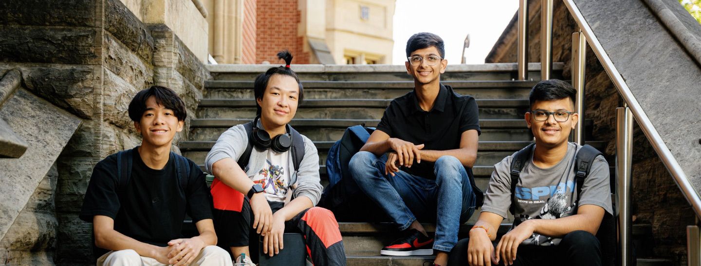 Male student outside views happy