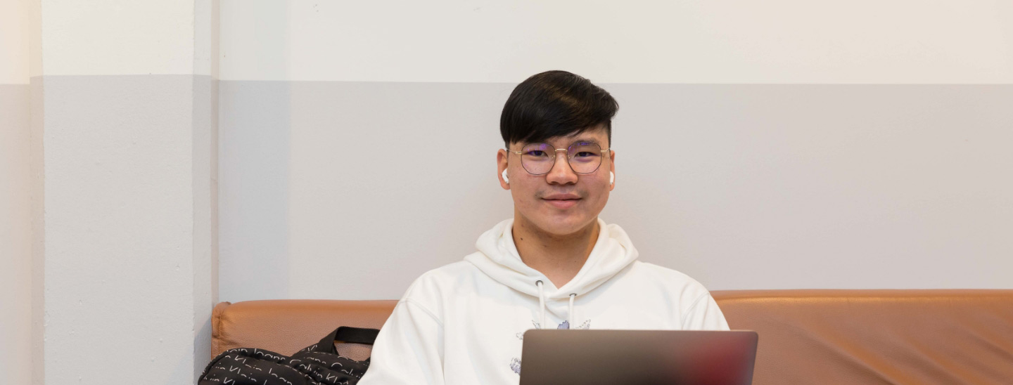 Male student sitting working