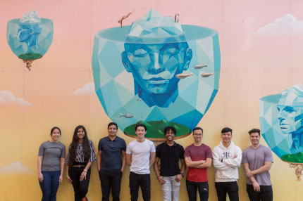 Students standing against wall