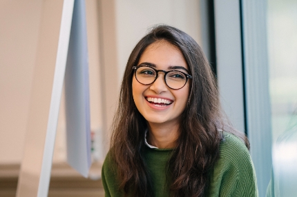 Student inside glasses laughing