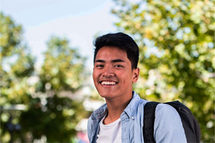 Student outside campus happy smiling