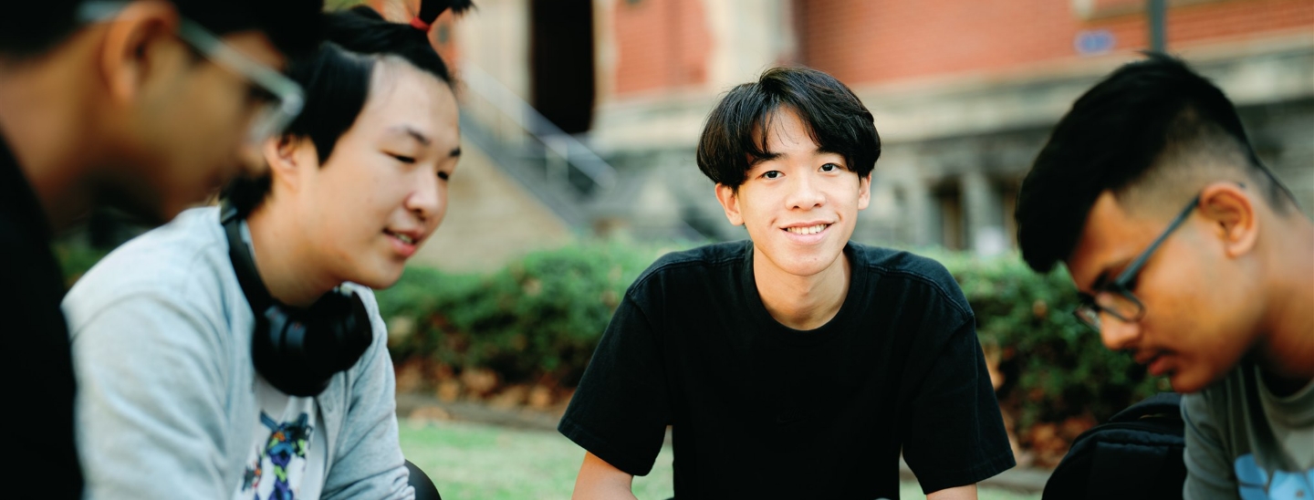 Student sitting outside happy smiling