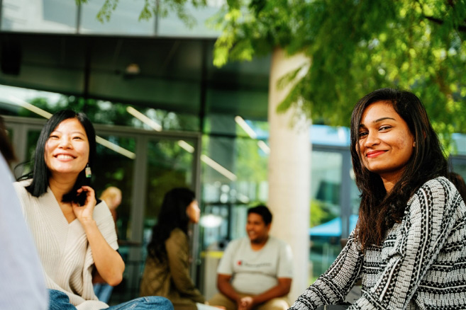 Students sitting outside socialising